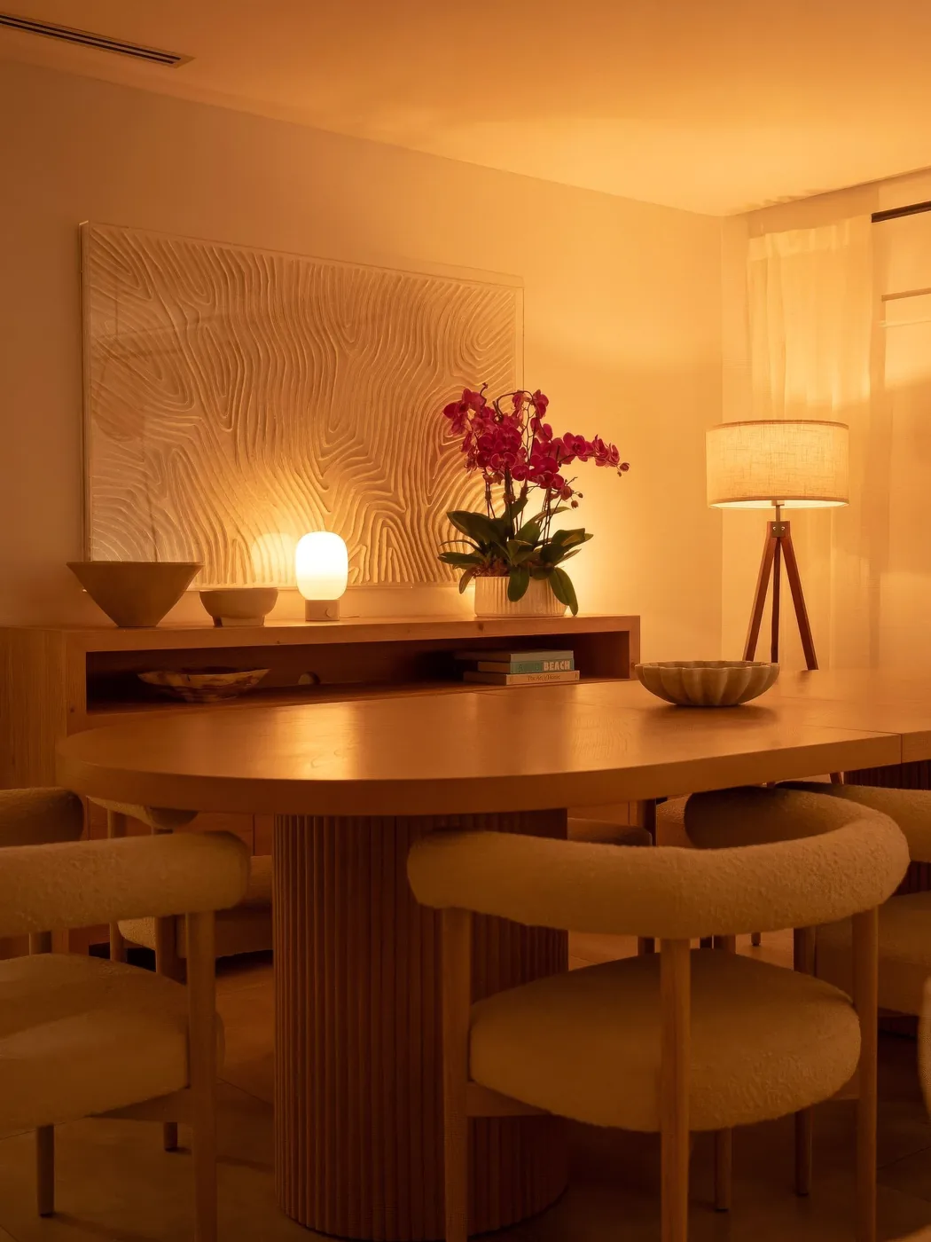 A dining room in a warm sunset glow, from @oasis_lighting